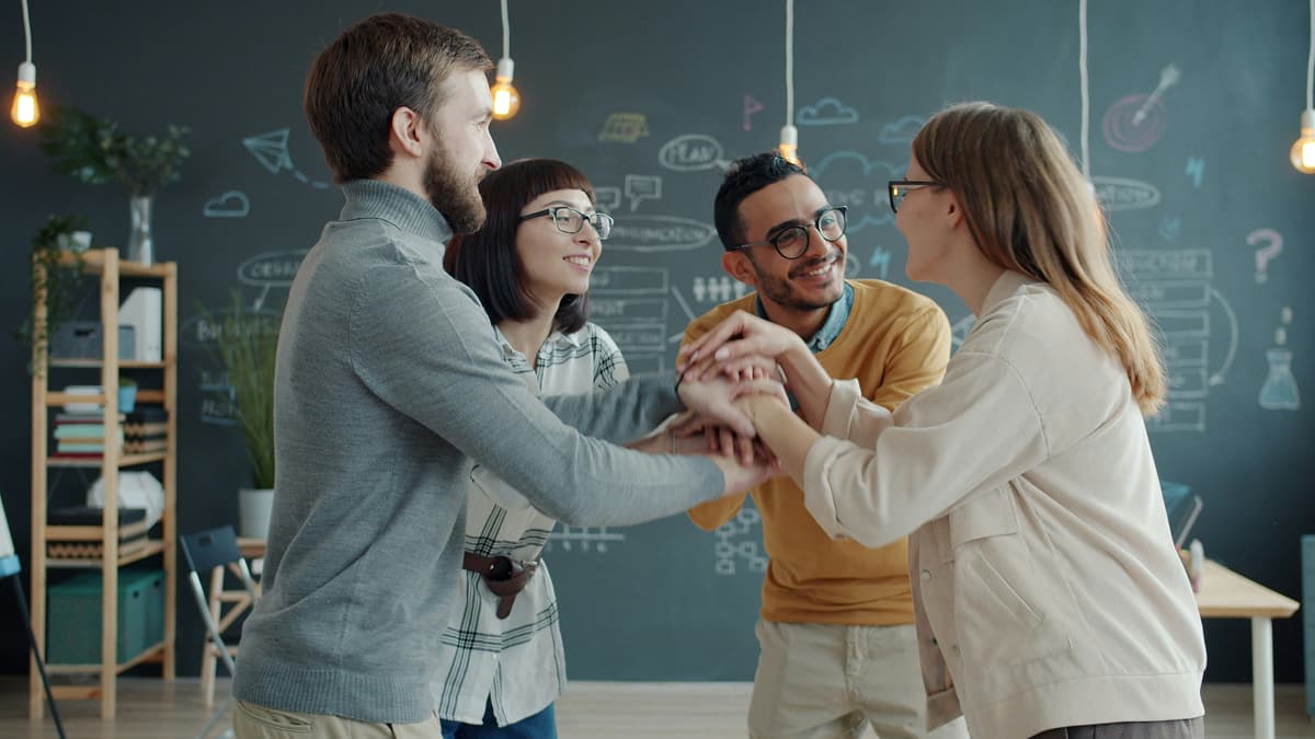 Developer pair programming with a senior colleague in a modern office